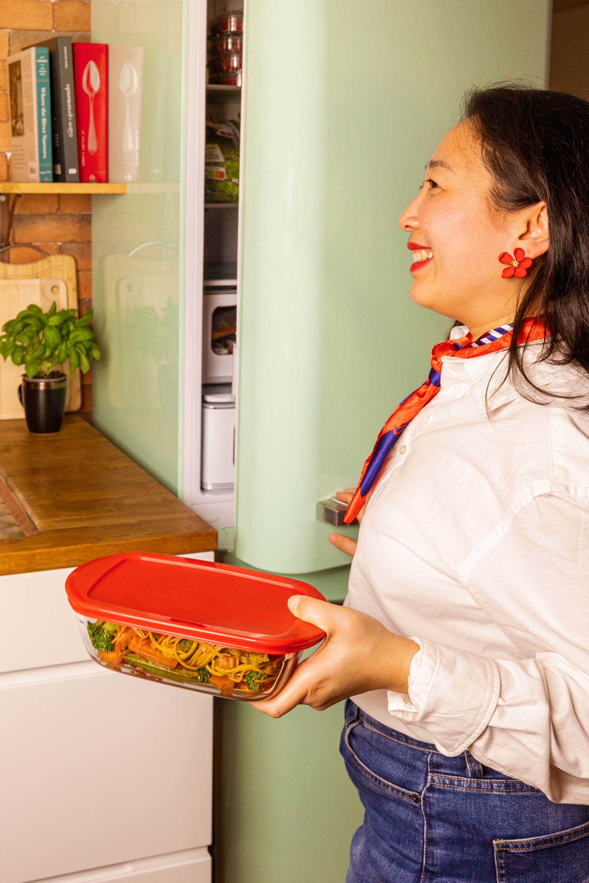 Woman holding an ÔCuisine rectangular storage container with lid  of salad in a kitchen